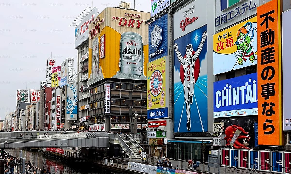 Osaka Namba Den-Den Town and Dotonbori area street scene representing the city's anime collab cafe district in 2026